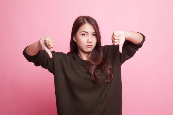 Unhappy Asian girl show thumbs down with both hands. — Stock Photo, Image