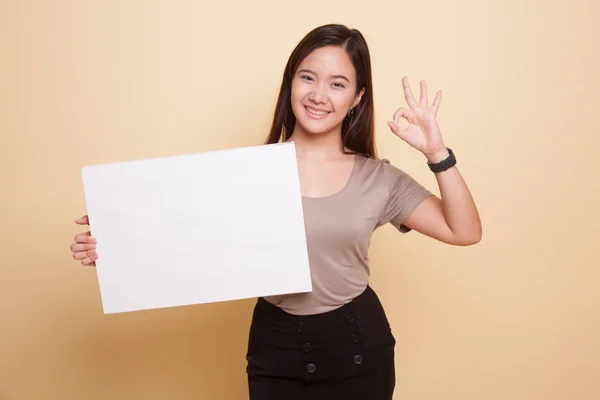 Young Asian woman show OK with white blank sign. — Stock Photo, Image