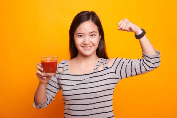 Strong healthy Asian woman with tomato juice. — Stock Photo, Image
