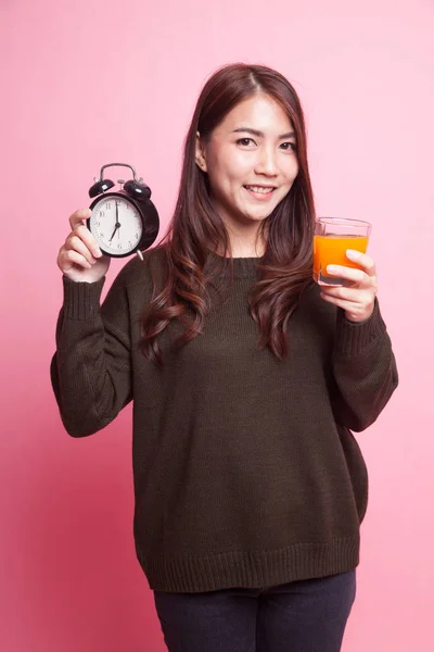 Ázsiai nő, egy óra narancs ital gyümölcslé. — Stock Fotó