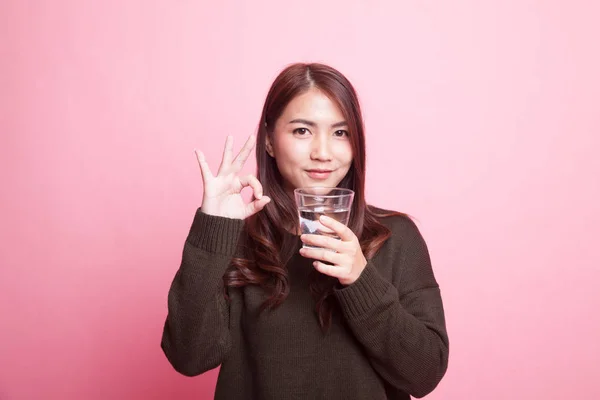 Giovane donna asiatica mostra OK con un bicchiere di acqua potabile . — Foto Stock