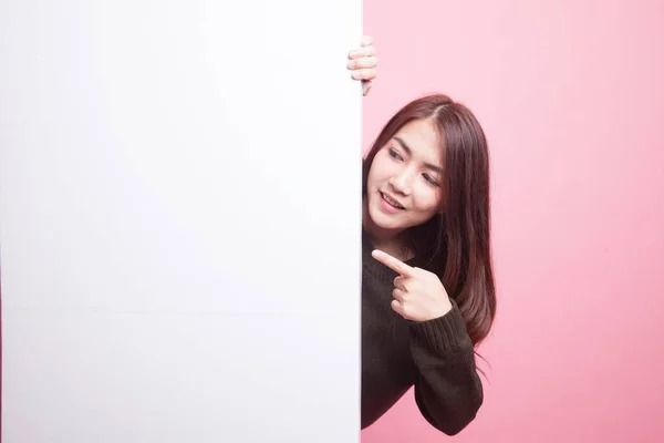 Young Asian woman point to a  blank sign. — Stock Photo, Image