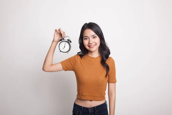 Young Asian woman with a clock. — Stock Photo, Image