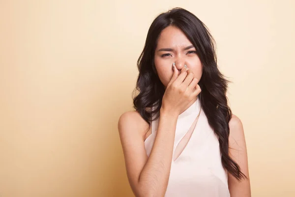 Kötü bir koku yüzünden burnunu tutan genç Asyalı kadın. — Stok fotoğraf