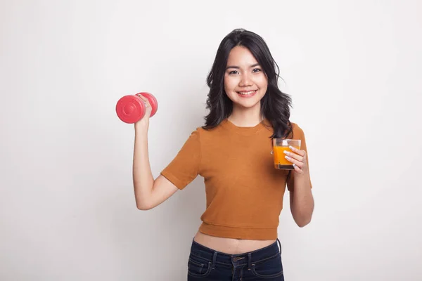 Young Asian woman with dumbbell drink orange juice. — Stock Photo, Image