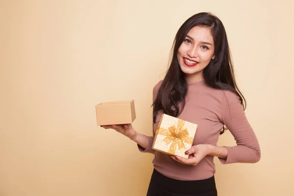 Giovane donna asiatica aprire una scatola regalo d'oro . — Foto Stock