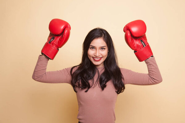 Молодая азиатка в красных боксёрских перчатках
.