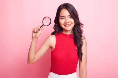 Bir büyüteç ile genç Asyalı kadın.