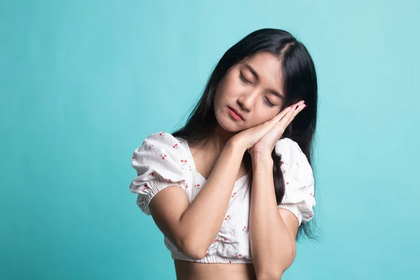 Beautiful young Asian woman with sleeping gesture. — Stock Photo, Image