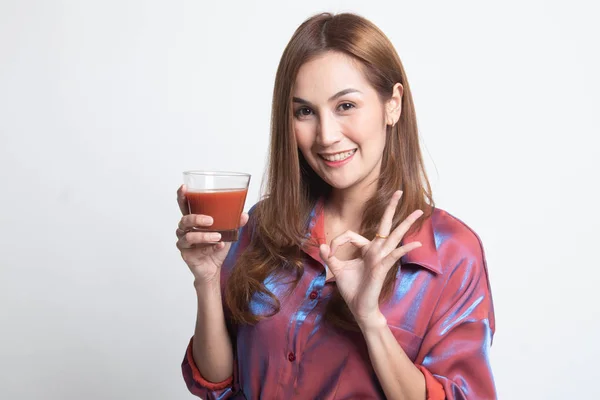 Young Asian woman show OK with tomato juice. — Stock Photo, Image