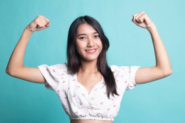 Güzel genç Asyalı kadın, arka planda kaslarını esnetiyor.