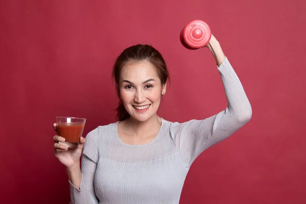 Healthy Asian woman with dumbbell and  tomato juice. — Stock Photo, Image