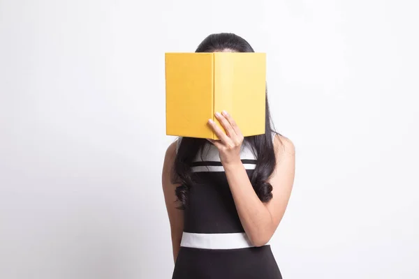 Young Asian woman with a book cover her face. — Stock Photo, Image