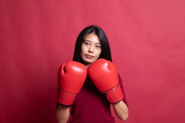 Young Asian woman with red boxing gloves.