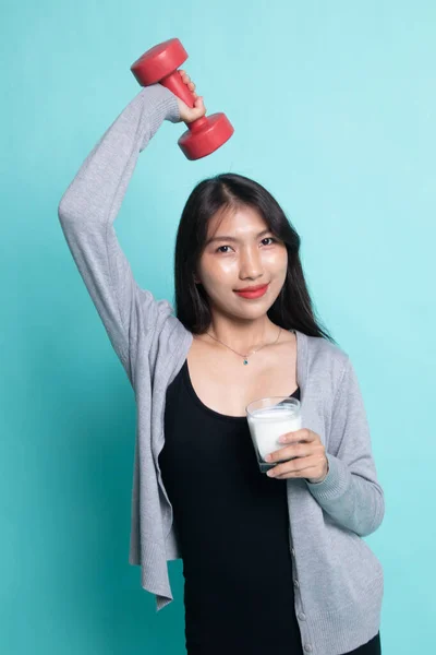 Mulher asiática saudável bebendo um copo de leite e haltere . — Fotografia de Stock