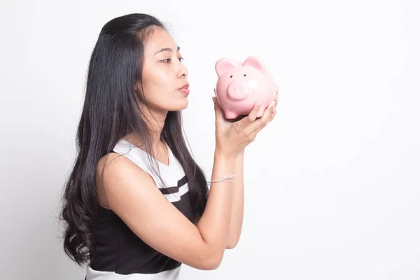 Young Asian woman kiss  a pink coin bank. — Stock Photo, Image