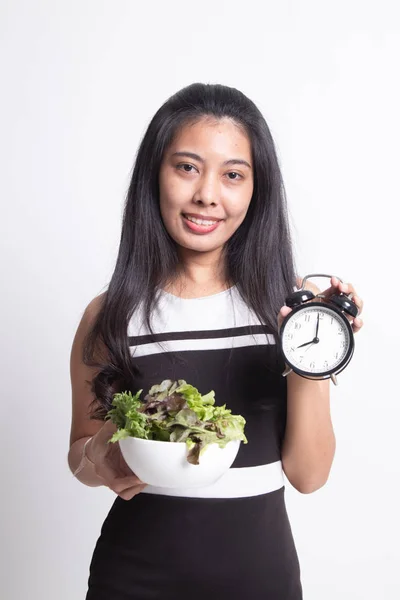 Ung asiatisk kvinna med klocka och sallad. — Stockfoto