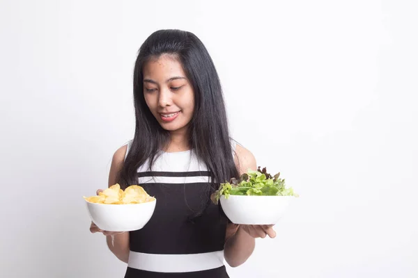 Jovem mulher asiática com batatas fritas e salada . — Fotografia de Stock