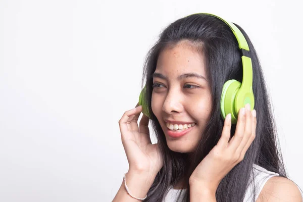 Mooi aziatisch meisje luisteren muziek met haar hoofdtelefoon. — Stockfoto