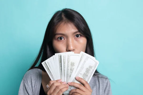 Portrét mladé asijské ženy ukazující hromadu bankovek — Stock fotografie