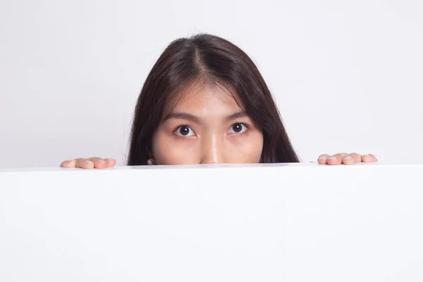 Close up of young Asian woman behind a blank sign. — Stock Photo, Image