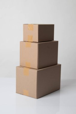 Pile of various size taped up  cardboard boxes