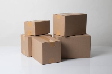 Pile of various size taped up  cardboard boxes