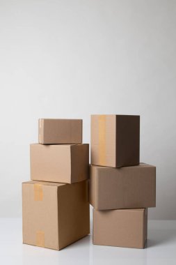 Pile of various size taped up  cardboard boxes