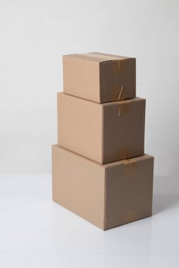 Pile of various size taped up  cardboard boxes