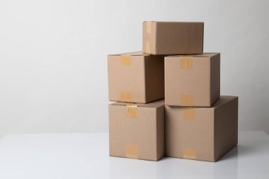 Pile of various size taped up  cardboard boxes