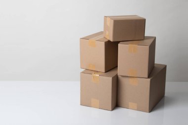 Pile of various size taped up  cardboard boxes