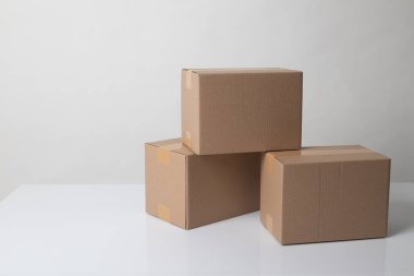 Pile of three  taped up  cardboard boxes