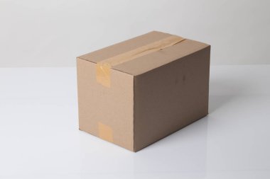 Closed cardboard box taped up ready to delivery