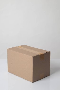 Closed cardboard box taped up ready to delivery