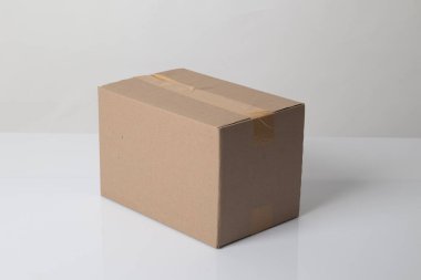 Closed cardboard box taped up ready to delivery