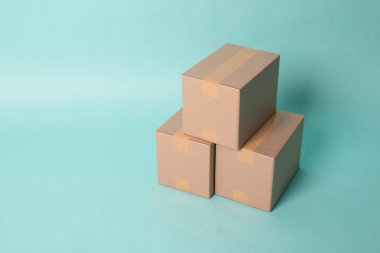Pile of three  taped up  cardboard boxes