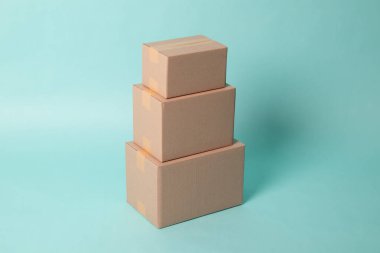 Pile of various size taped up  cardboard boxes
