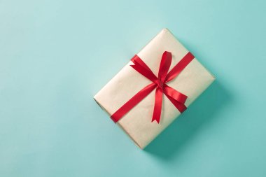 Kırmızı kurdele ile altın hediye kutusu