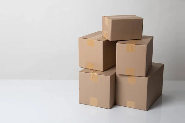 Pile of various size taped up  cardboard boxes — Stok fotoğraf