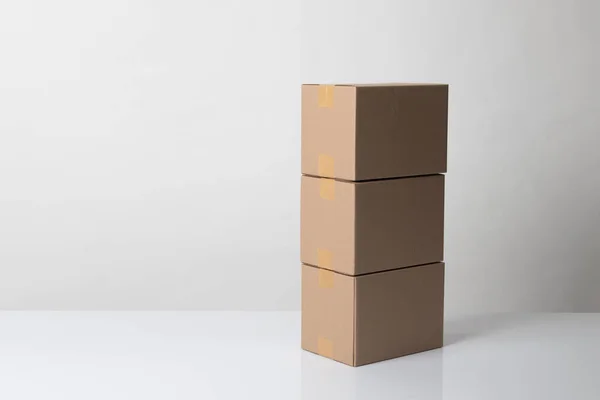 Pile of three  taped up  cardboard boxes — 스톡 사진