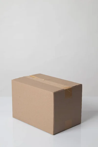 Closed cardboard box taped up ready to delivery — 图库照片