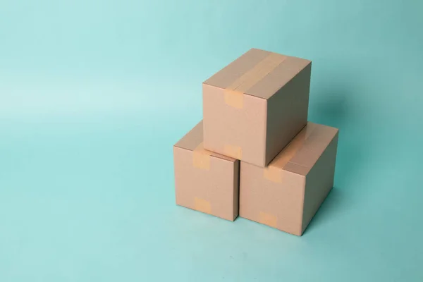 Pile of three  taped up  cardboard boxes — Stok fotoğraf