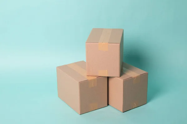 Pile of three  taped up  cardboard boxes — Stock Photo, Image