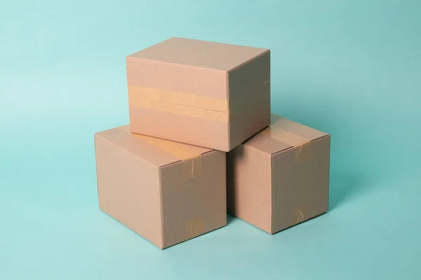 Pile of three  taped up  cardboard boxes — Stockfoto