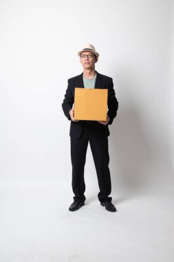 Teslimat, taşınma ve boşaltma. Yetişkin bir Asyalı beyaz arka planda karton kutu tutuyor.