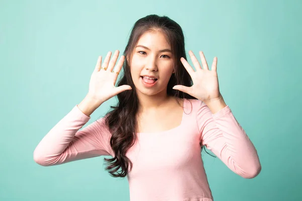 Young Asian Woman Sticking Her Tongue Out Cyan Background — Stock Photo, Image