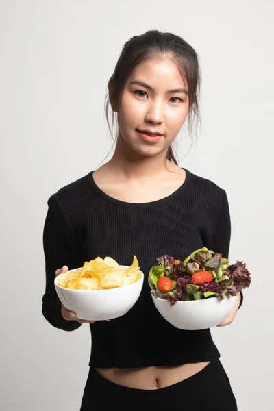 Junge Asiatische Frau Mit Kartoffelchips Und Salat Auf Weißem Hintergrund — Stockfoto