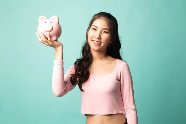 Young Asian Woman Pig Coin Bank Cyan Background — Stock Photo, Image