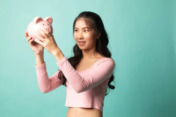 Young Asian Woman Pig Coin Bank Cyan Background — Stock Photo, Image