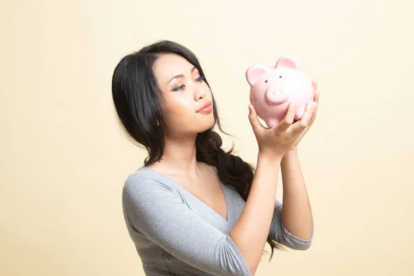 Young Asian Woman Kiss Pink Coin Bank Beige Background — Stock Photo, Image